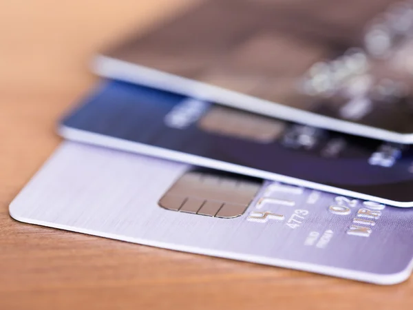 Stack of credit cards on wooden desk selective focus — Stock Photo, Image