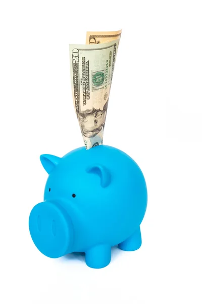 Dollar banknote putting into blue piggy bank on white background — Stock Photo, Image