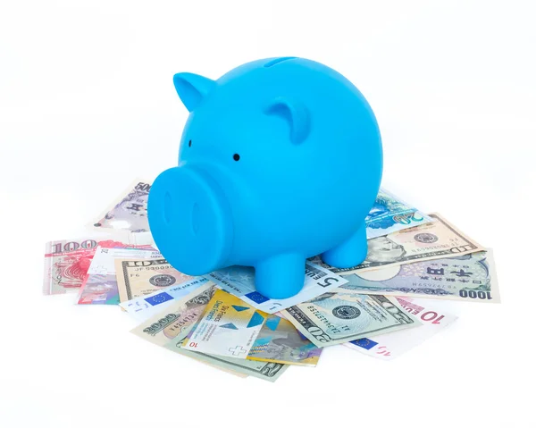 Blue piggy bank on international banknote — Stock Photo, Image