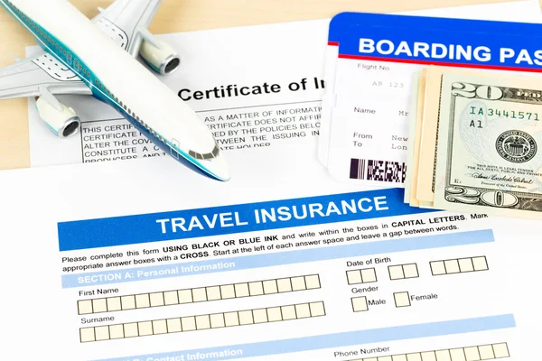 Travel insurance application form with plane model and boarding — ストック写真