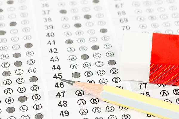 Filled answer sheet with eraser focus on pencil — Stock Photo, Image