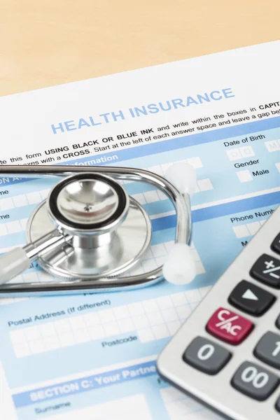 Health insurance application form with calculator and stethoscop — Stock Photo, Image