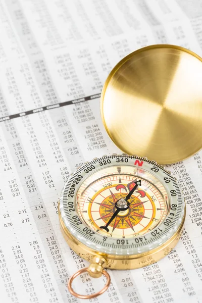Compass on stock price report investment concept — Stock Photo, Image