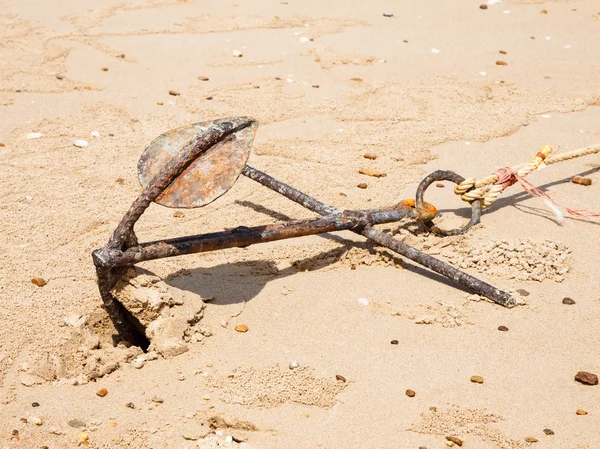 Petite ancre traditionnelle rouillée sur une plage — Photo
