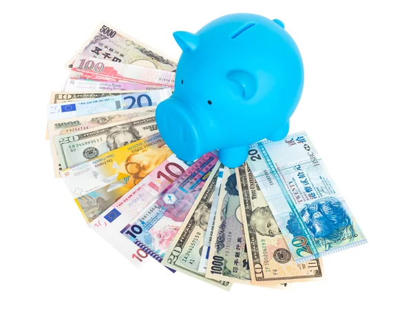 Blue piggy bank on international banknote — Stock Photo, Image