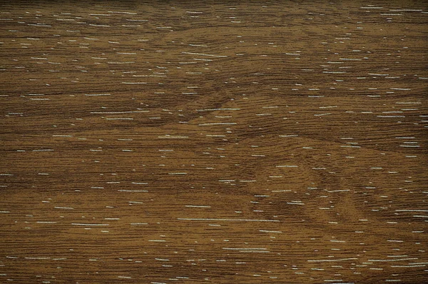 Dark walnut wavy pattern of natural wood close-up. Background pattern texture.