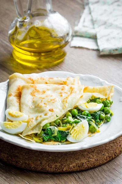 Pancakes, crepes stuffed with green peas, spinach, leeks, Russia — Stock Photo, Image