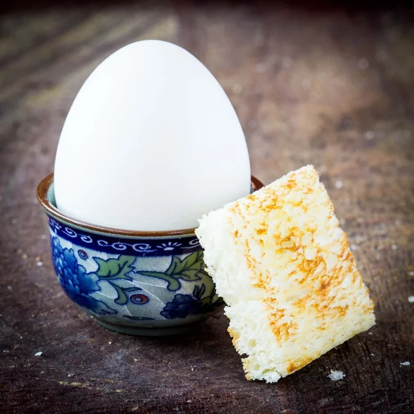 Rustic breakfast, boiled egg with golden crunchy toast — Stock Photo, Image