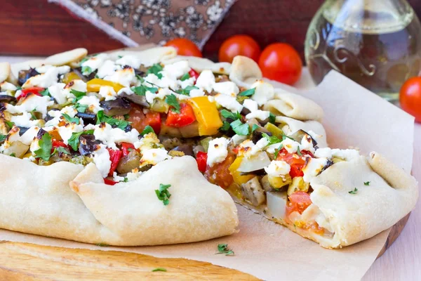 Vegetable pie with eggplant, zucchini, peppers, feta cheese, par