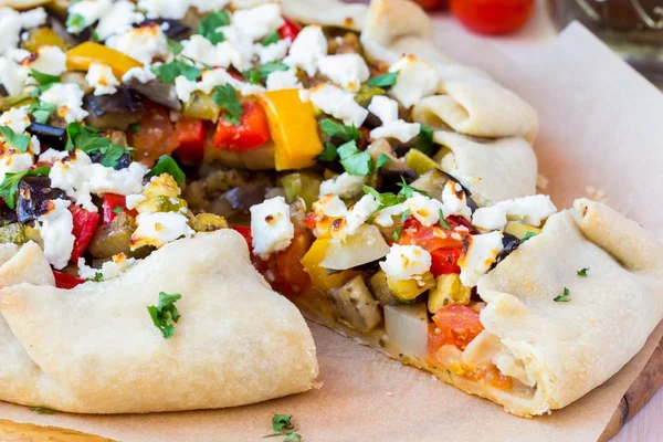 Vegetable pie with eggplant, zucchini, peppers, feta cheese, par