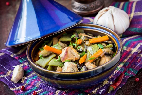 Oriental stew with meat, vegetables, green beans, carrot in tagi