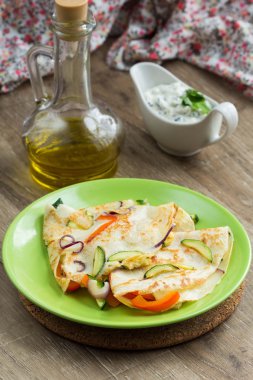 İnce krep üzerinde sebze ve Yunan sos, krep ile doldurulmuş