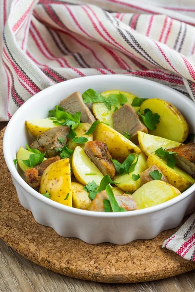 Baked jacket potatoes with meat in oven, homemade dish — Stock Photo, Image