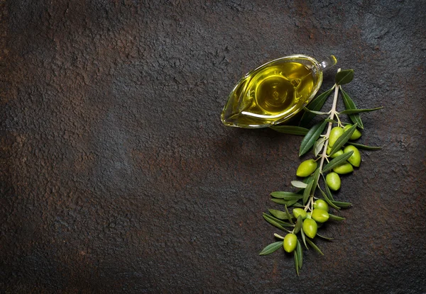 Branch with olives and olive oil, above view. — Stock Photo, Image