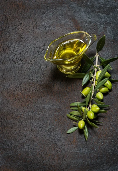 Twig with olives and olive oil — Stock Photo, Image