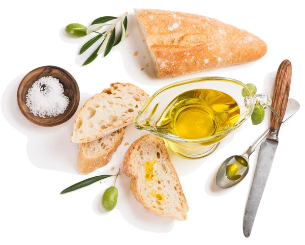 Olive oil and slices of baguette, above view. — Stock Photo, Image