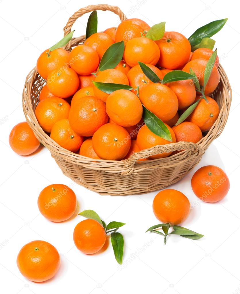 Mandarins with green leaves in a wicker basket