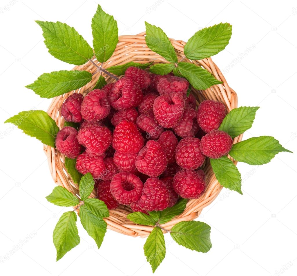 Basket of raspberries with leaves, top view