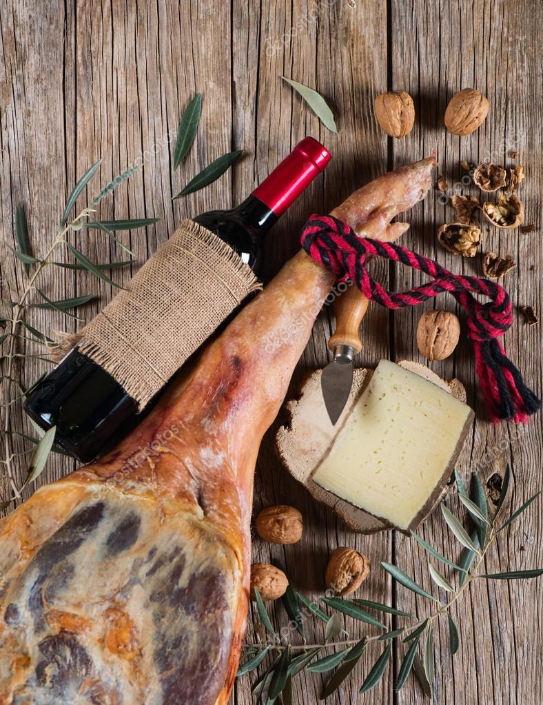 Cured ham leg, spanish tapas, glass and bottle of red Stock Photo by