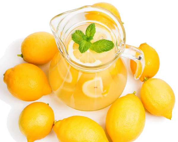 Lemonade in the jug and lemons with mint — Stock Photo, Image