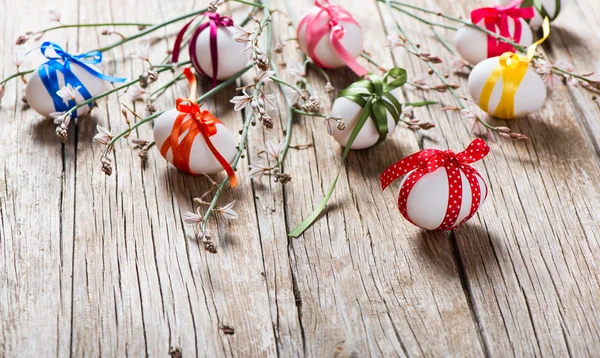 Easter eggs and branch with flowers — Stock Photo, Image