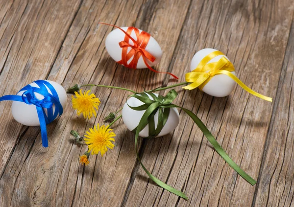 Easter eggs with color ribbons — Stock Photo, Image