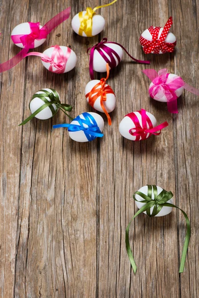 White eggs with colorful ribbons — Stock Photo, Image