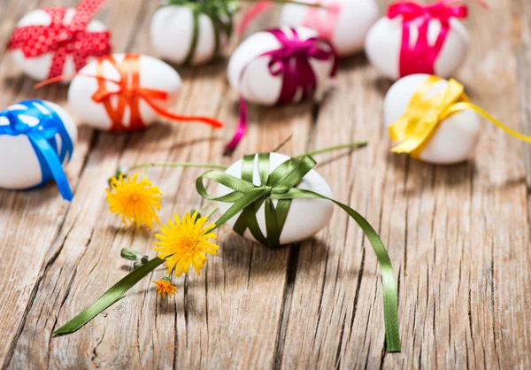 Easter eggs with varicolored ribbons — Stock Photo, Image