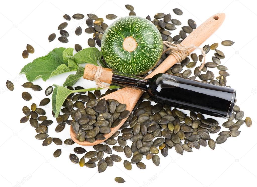 Pumpkin seed oil, raw pumkin and seeds, view from above
