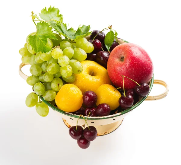 Various fruits in colander — Stock Photo, Image