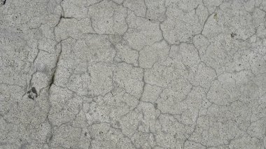Kumaşın dokusu ve arkaplanı. Asfalttaki benzersiz çatlak deseni