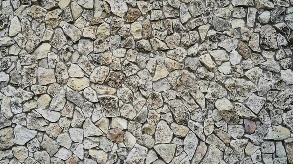 Kumaşın dokusu ve arkaplanı. Taş dekoratif duvarın eşsiz dokusu, duvardaki taşlar.
