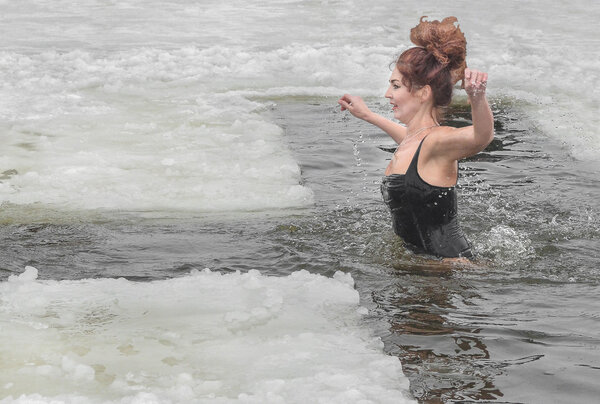 Зимой женщины купались в реке. Христианский праздник Богоявления. Плавание в реке зимой. Здоровый образ жизни. Люди купаются в реке зимой в городе Самара Новомосковске Днепропетровской области 19 января 2016 года

