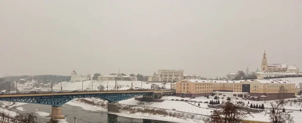 Winter city. A city covered in snow. Bridge over river