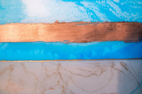 Part of original resin art, epoxy resin painting. Fluid art for modern banners, ethereal graphic design. Abstract ethereal gold, bronze, blue and white swirl. Marble texture.