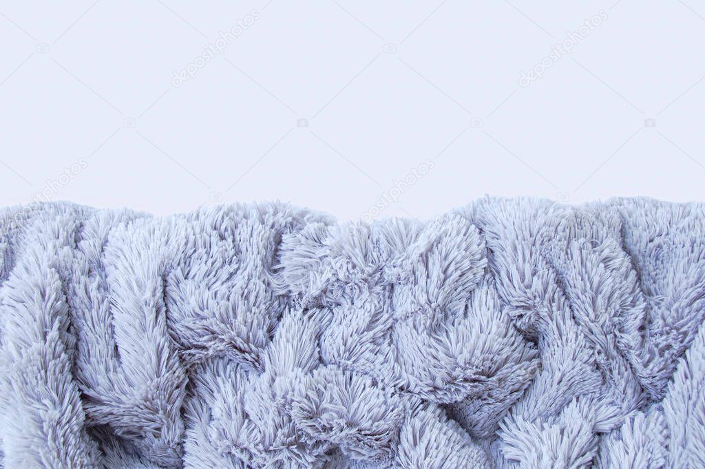 Gray fur blanket. White background from above. Place for your text.