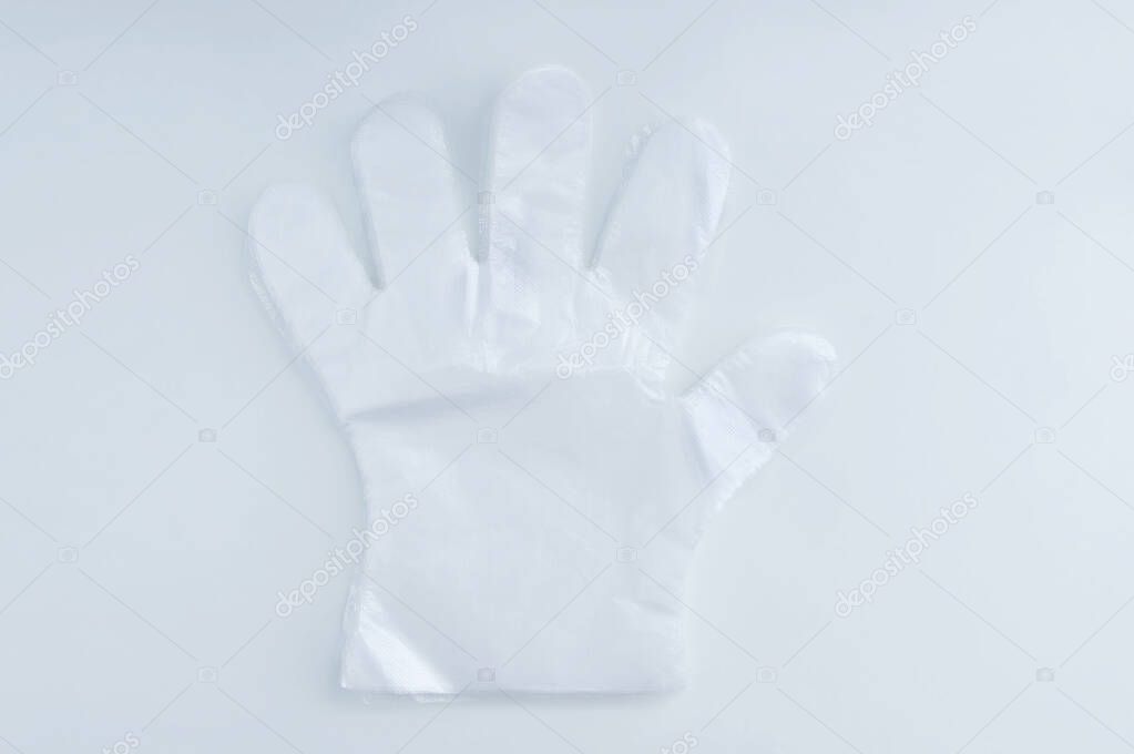 Transparent polyethylene disposable protective gloves on a white background.