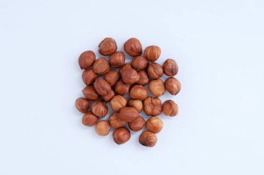 Beyaz arka planda bir avuç soyulmuş fındık..