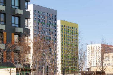 Parlak güneşin altında yüksek binalar. Moskova 'nın yeni bölgeleri büyüyor. Parlak gökyüzüne karşı evler.