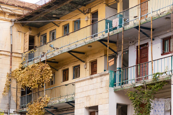 Shared balconies in Sevastopol courtyards. Preserved courtyards with climbing vines. Pleasant autumn in Sevastopol.