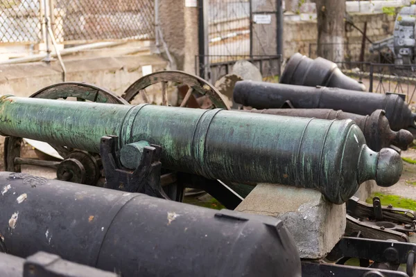 An old ship\'s cannon. Weapons on a pedestal at a historic building in Sevastopol.