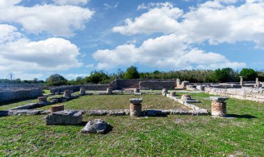 Ancient Greek ruins and stone columns at the Archaeological Park of Paestum, Italy