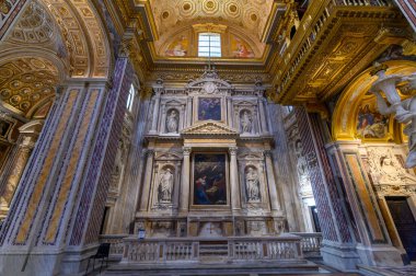 Naples, Italy. Interior of the Girolamini Church (Chiesa dei Girolamini), featuring a spectacular golden coffered ceiling and marble columns.