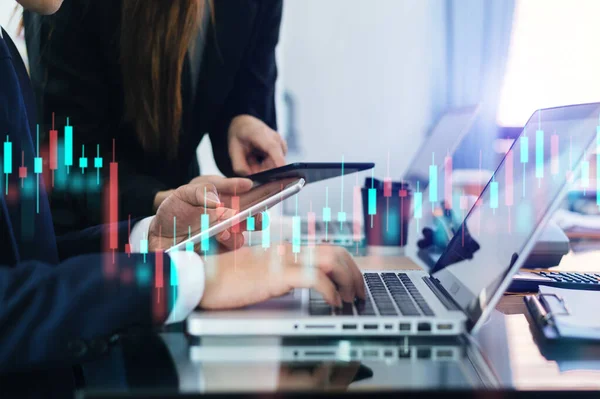 Two professional traides on technical price graph and indicator, red and green candlestick chart and stock trading computer at offic