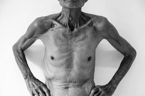 old man Skinny torso in a black and white background. Copy spac