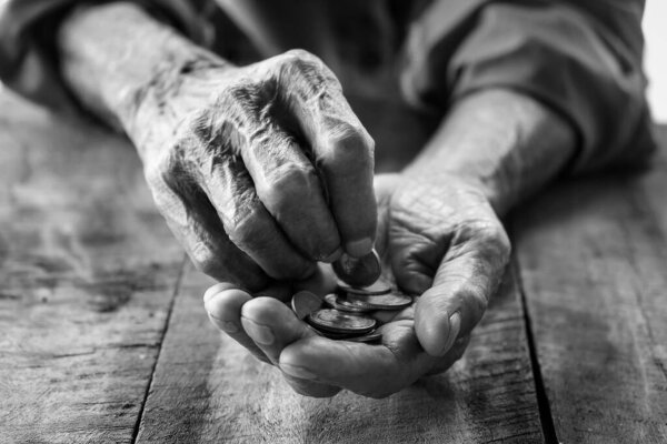 hand old man begging for money because of the hunger on the wood table. black and whit