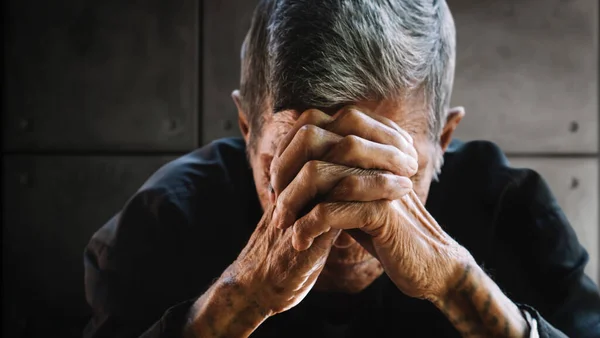 senior man covering his face with his hands. Depression and anxiety Copy space