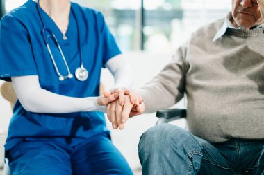 Yaşlı erkeklerin ellerine dokunan kadın elleri yaşlı kavramların icabına bakar. Hastanede.