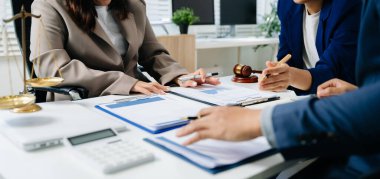 Adalet ve hukuk kavramı. Beyaz masadaki bir mahkeme salonunda erkek yargıç ve ofiste çalışan avukat ya da takım avukatı..