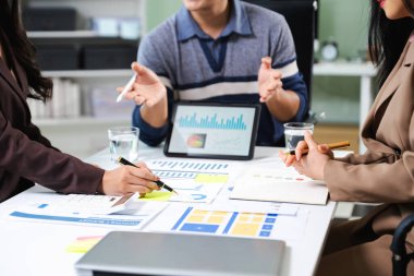 İş ekibi toplantısı. Finans müdürüyle çalışan profesyonel bir yatırımcı. Bilgisayarlı akıllı telefon ve dijital tablet ile sabah ışığında